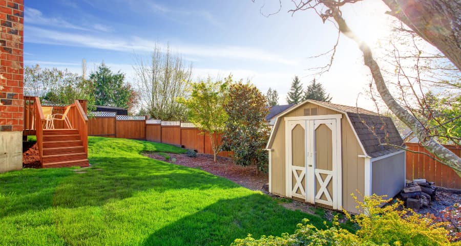 Fenced backyard with storage shed in Provo